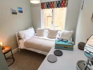 ein kleines Schlafzimmer mit einem Bett und einem Fenster in der Unterkunft Dodds Nook in Alnwick
