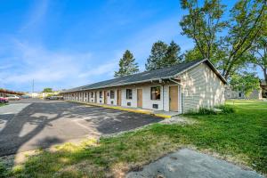 a building with a parking lot next to a street at Great Lakes Inn & Suites in South Haven