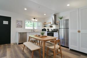 a kitchen with a table and chairs and a refrigerator at Moab Inn Towner #2 - Heart of Downtown in Moab