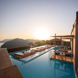 a hotel with a pool with a view of the ocean at ALETRI new swim up HOTEL in Alonnisos