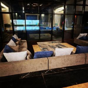a living room with a couch and pillows at مزرعة الاسترخاء in Umm Al Quwain