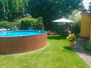 a swimming pool in a backyard with a grass yard at Apartment BENCI in Jindrichuv Hradec
