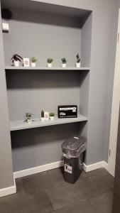 a room with shelves with potted plants and a trash can at Flensburg Süd in Flensburg