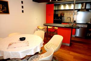 a kitchen with a white table and chairs and a counter at Isabella in Silba +29 photos