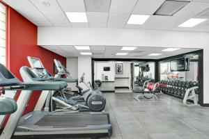 a gym with cardio equipment and red walls at Intracoastal Waterview - Central- Fort Lauderdale - Steps to Beach in Fort Lauderdale
