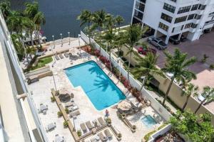 an overhead view of a swimming pool with palm trees and a building at Intracoastal Waterview - Central- Fort Lauderdale - Steps to Beach in Fort Lauderdale