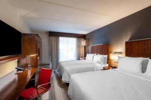 a hotel room with two beds and a television at Four Points by Sheraton Atlanta Airport West in Atlanta +20 photos