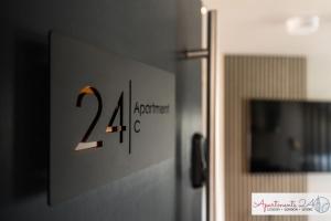 a sign on a door with the number on it at Beautiful Studio Apartment - London in Hounslow +3 photos