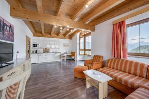 a living room with a couch and a table at Ferienhaus Platöll in Serfaus