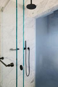 um chuveiro com uma porta de vidro na casa de banho em Renaissance New York Midtown Hotel em Nova Iorque