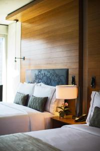 a bedroom with two beds and a wall with wood at Renaissance New York Midtown Hotel in New York