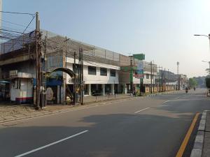 an empty street in a city with a building at Hotel Syariah Taman Cibinong 2 By FPH 