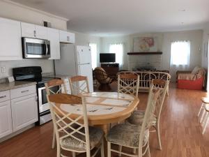 a kitchen and dining room with a table and chairs at Blue Haven Apartments in Ocean City