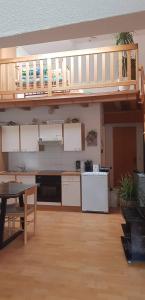 a kitchen with a loft with a table and a kitchen at green hill in Bad Kleinkirchheim