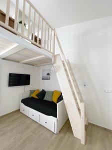 a bedroom with a bed under a staircase at Comfortable apartments under the St. Barbara´s Cathedral in Kutná Hora