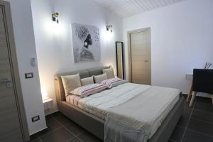 a bedroom with a large bed with two pillows at Alpaca Etna Rooms da Mariagiovanna in Linguaglossa