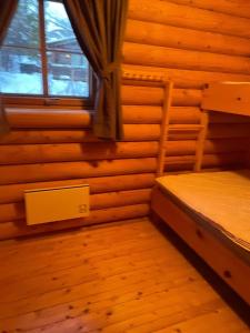 an empty room with a bed and a window at Hovden in Hovden