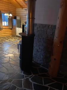 a stone floor with a stove in a room at Hovden in Hovden