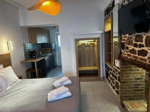 a bedroom with a bed with two towels on it at Eleni B&B in Limánion