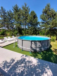 a trampoline in a yard with a pool at Borsko jezero in Bor