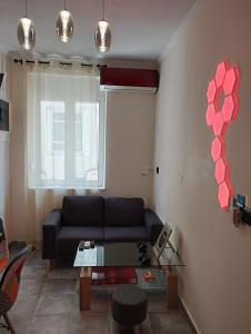 a living room with a couch and a table at Arcade City Apartment in Rethymno