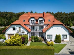 a large house with an orange roof at Willa Bałtyk in Karwia