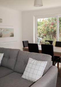 a living room with a couch and a table with chairs at Lovely Bungalow Close to Beach in Prestatyn