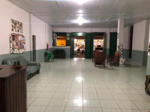 a room with a lobby with green and white tile floors at NOVO HOTEL SOURE in Soure