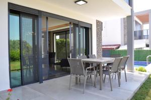 a dining room with a table and chairs at Villa Elite in Kusadası