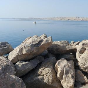 a group of rocks on the shore of a body of water at Apartman Čardak in Gospić