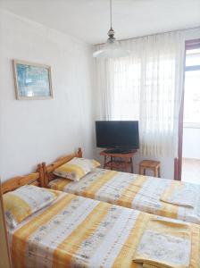 Postel nebo postele na pokoji v ubytování Kiki - family apartment + 4 fotografie