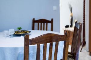 a dining room table with a plate of food on it at Irene's home in Igoumenitsa