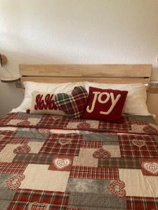 a bed with some pillows on top of it at Residence Larici Belvedere in Folgarida +17 photos