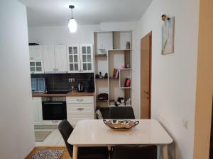 a kitchen with a table with a bowl on it at Cozy near City Center Apartment! in Pristina