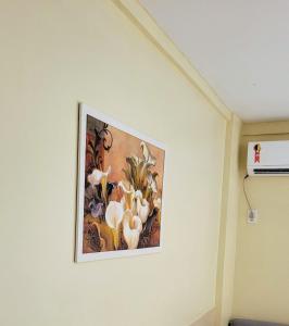 a picture of flowers on a wall in a room at Gran Lençóis Flat Residence Barreirinhas - Mandacaru 211 in Barreirinhas