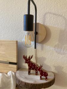 a lamp on a table with two reindeer on it at Residence Larici Belvedere in Folgarida