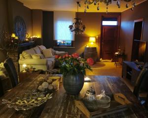 a living room with a table with flowers on it at La Constance 