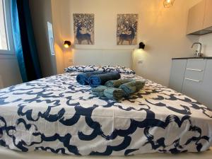 a bedroom with a large bed with blue and white sheets at Studio Milano 33 in Milan