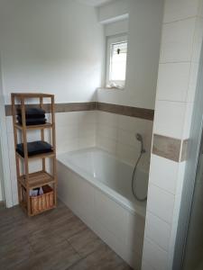 a bathroom with a bath tub and a window at Lausitzer Auszeit in Laubusch +53 photos