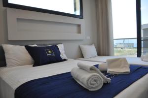 a bedroom with two beds with towels on them at Villa Elite in Kusadası