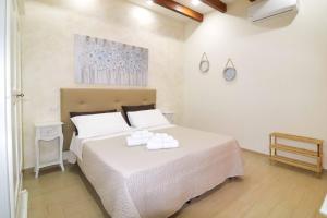 a bedroom with a large white bed with white pillows at santa potenza in Felline