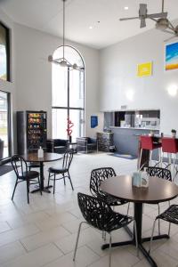 a restaurant with tables and chairs in a room at Days Inn by Wyndham Amarillo - Medical Center in Amarillo