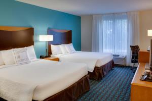 a hotel room with two beds and a window at Fairfield by Marriott Inn & Suites Melbourne West/Palm Bay in Melbourne