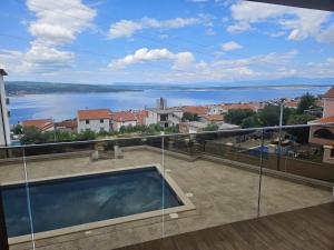 a balcony with a view of a body of water at Apartment Ankica in Crikvenica