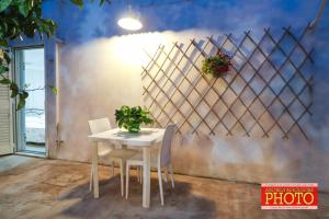 a table and chairs in front of a wall at santa potenza in Felline +38 photos