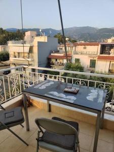 a balcony with a table and chairs on a balcony at Mixaleas apartments in Kalamata