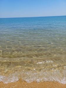 a large body of water with a sandy beach at Casa sul mare in Ovile la Marinella