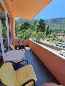 a room with a balcony with a view of a road at Marinero Apartments in Kotor