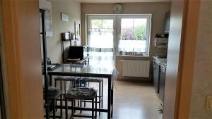 a kitchen with a counter with stools and a window at FeWo Weismark in Trier