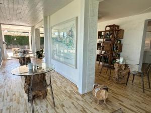 a room with two tables and a painting on the wall at Adagio Salentino in Porto Cesareo